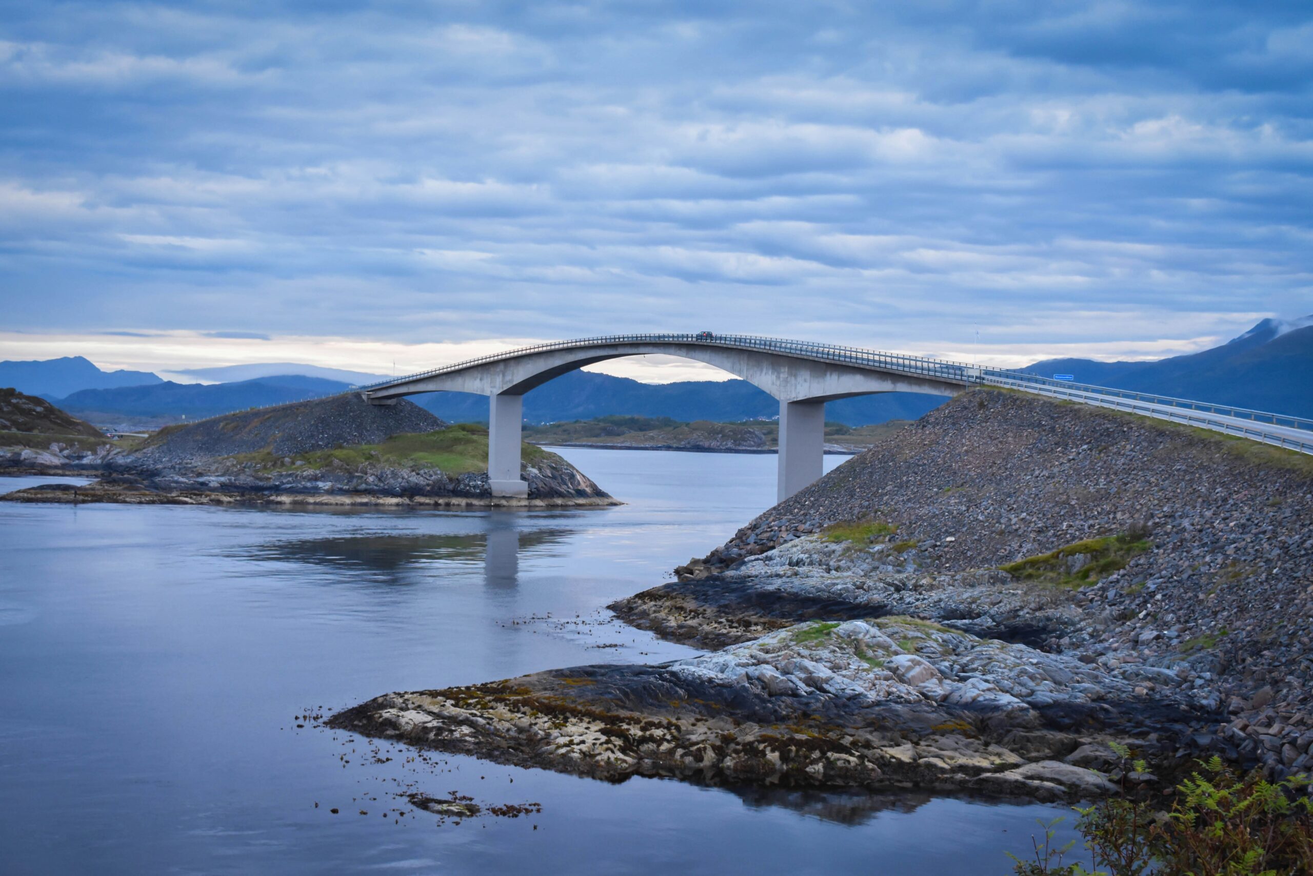 white concrete bridge under white and blue sky at daytime